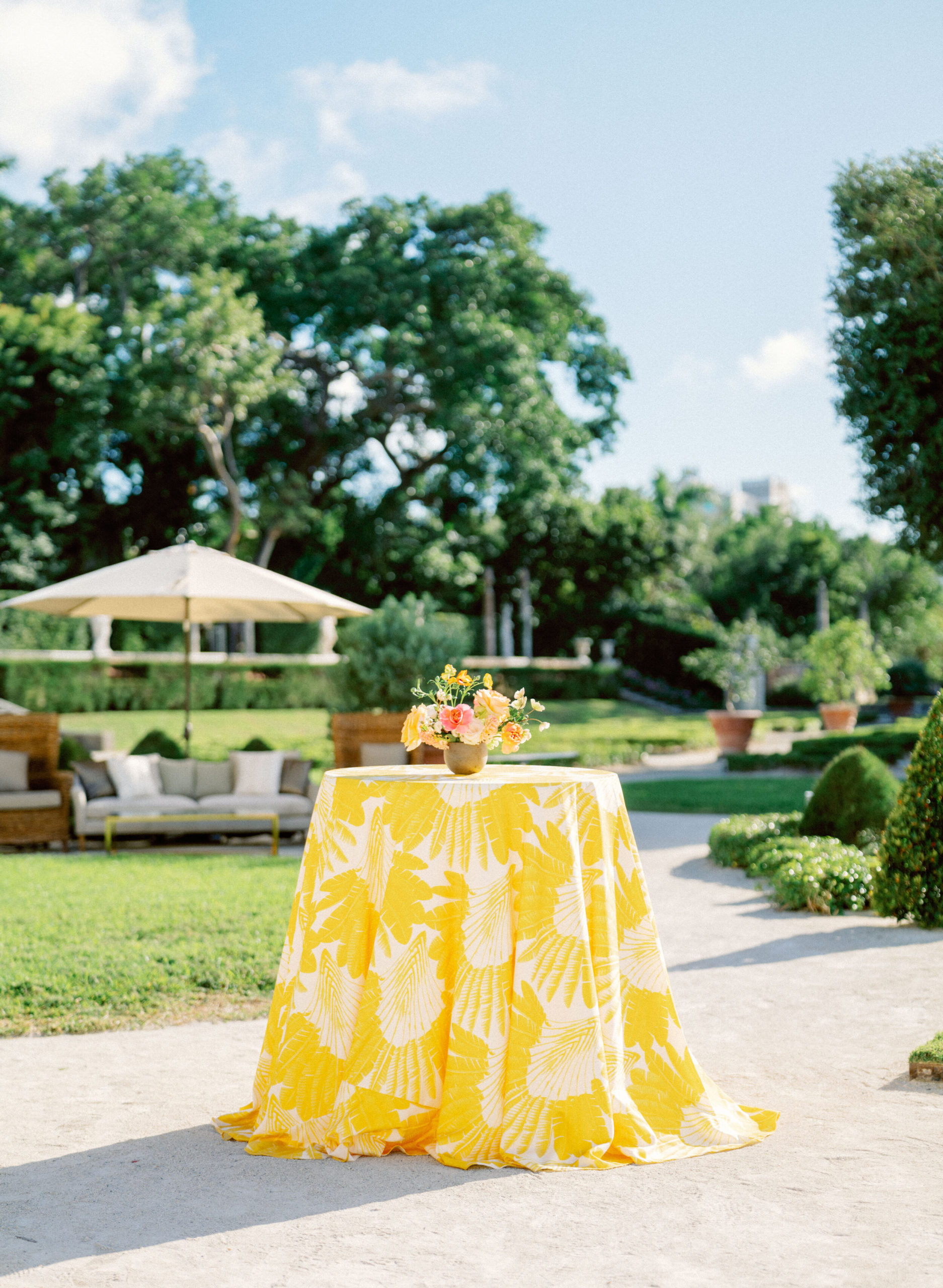 colorful, yellow print linen on cocktail table for outdoor wedding at Vizcaya Museum
