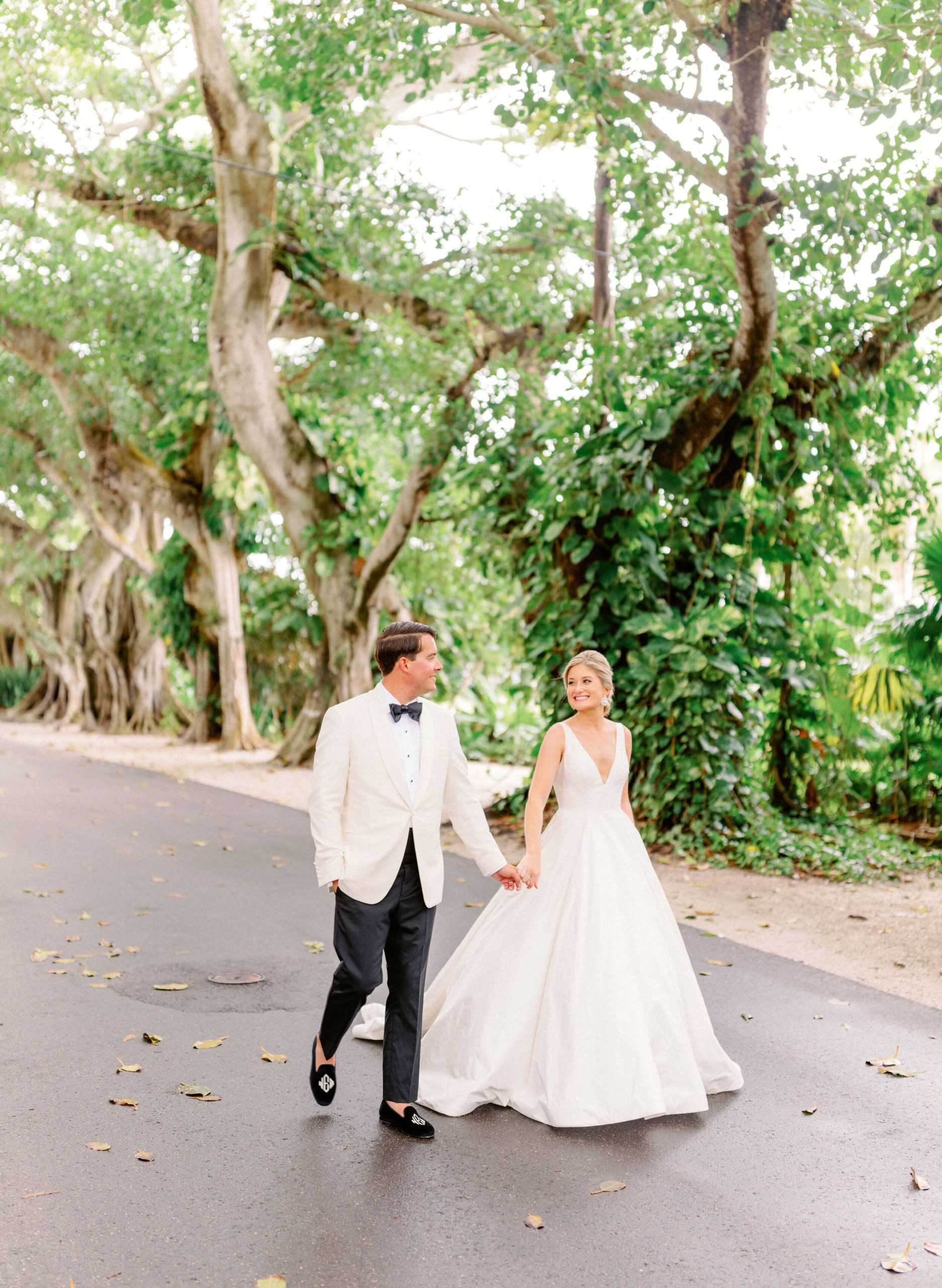Couplw walking through the Banyan Trees at Gasparilla Inn in Boca Grande