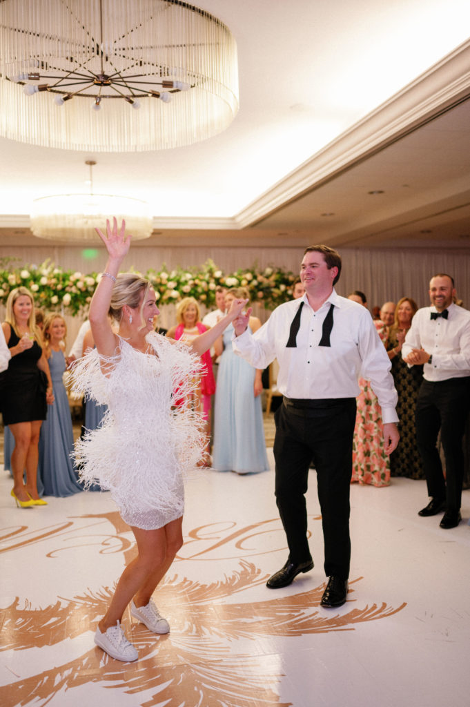 Couple dancing on custom dance floor at their destination wedding in Naples at LaPlaya Beach Resort