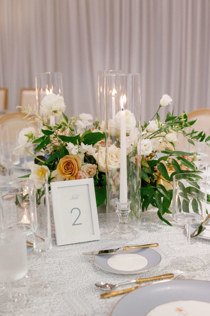 Centerpiece with peach and white florals, indoor reception at LaPlaya