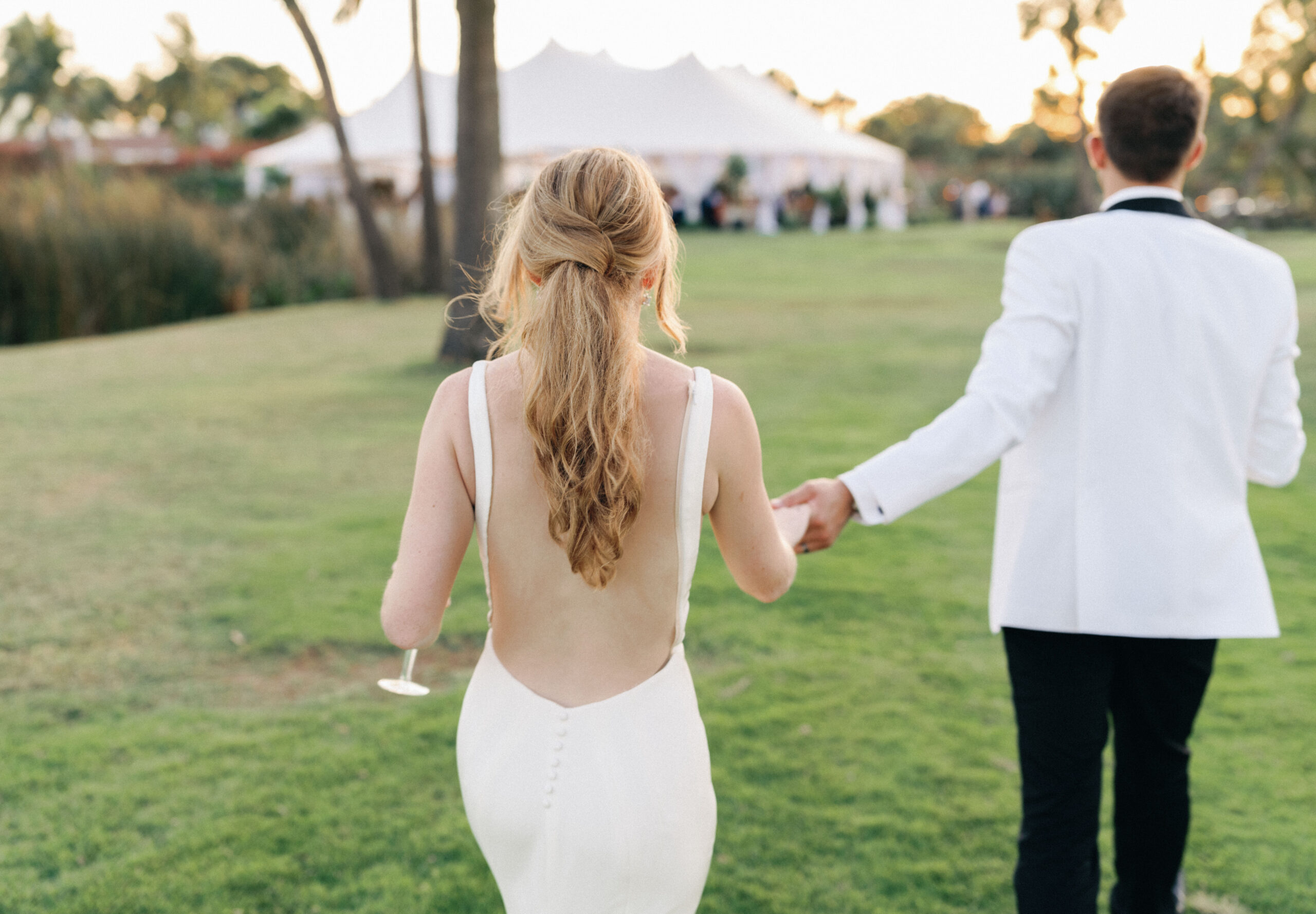 bride with low back dress and ponytail