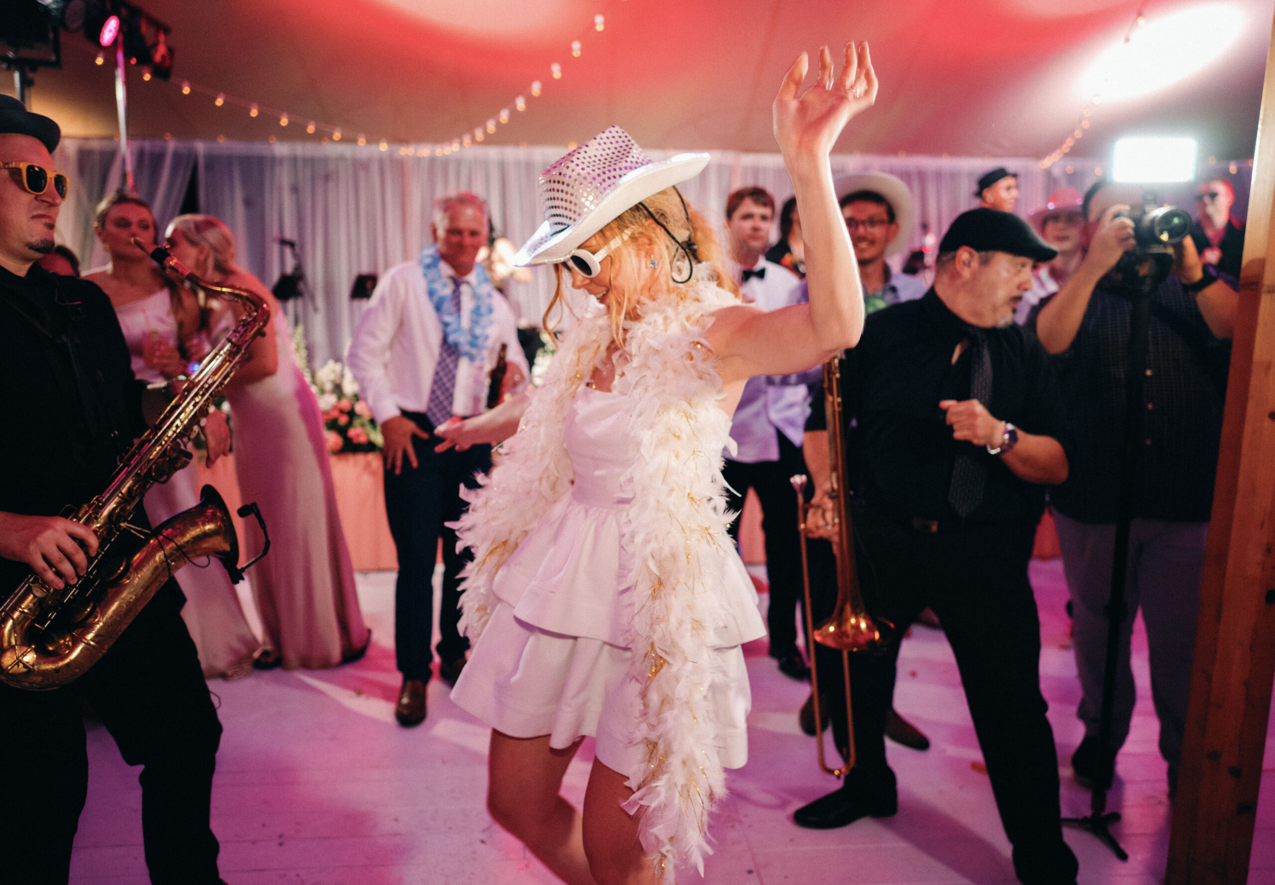 bride in her second look cocktail style wedding dress, cowboy hat and fringe boa