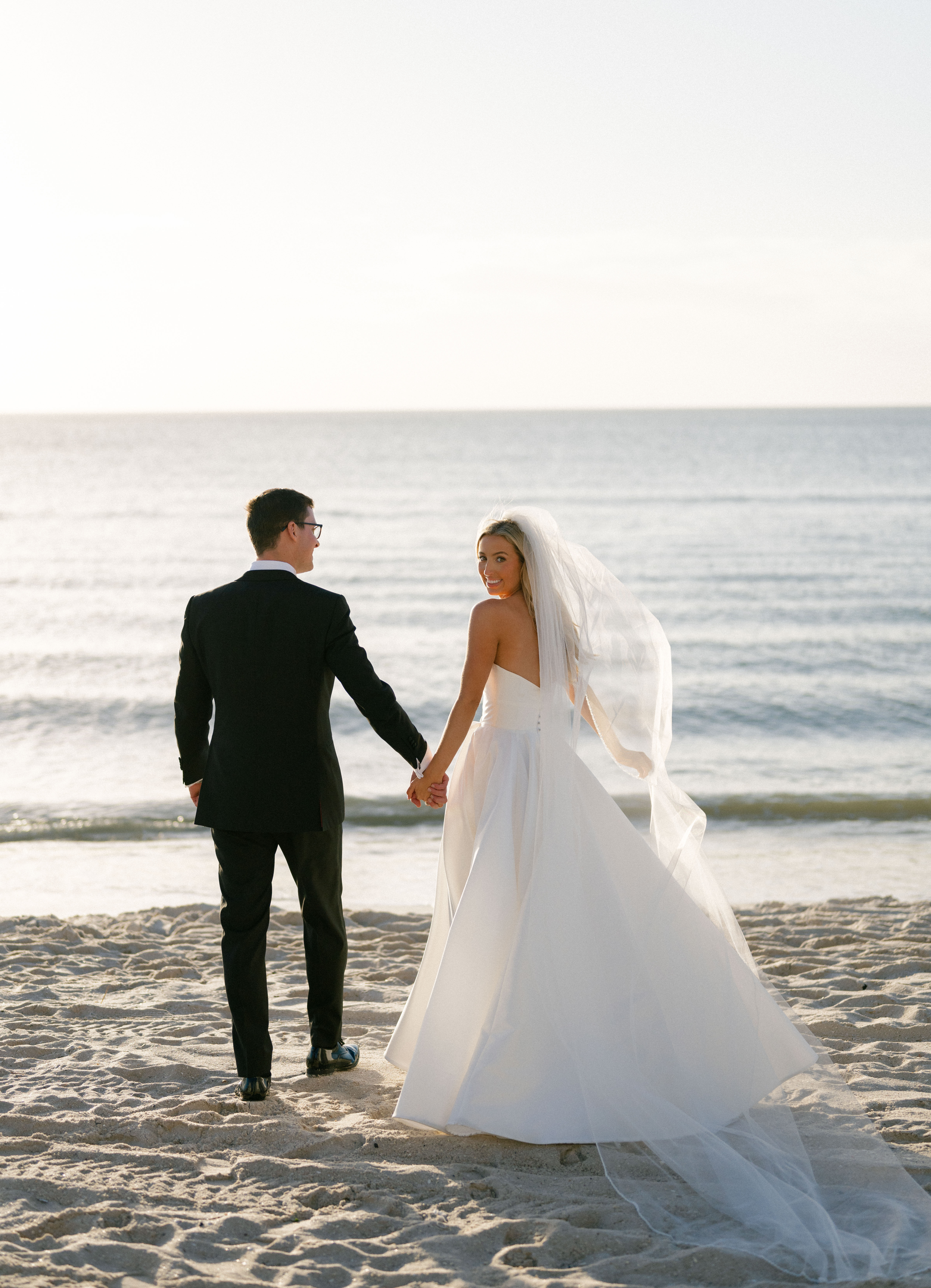 A couple taking portraits on a beach in Florida.