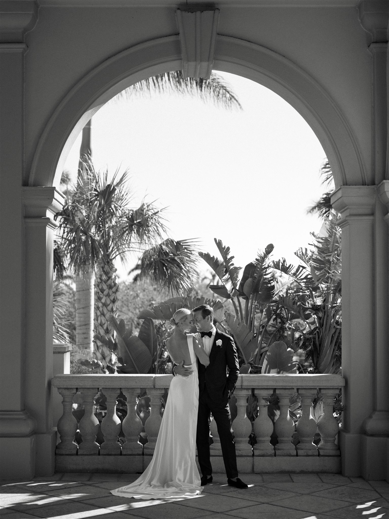 Newlywed couple underneath arch at Ritz Carlton Naples