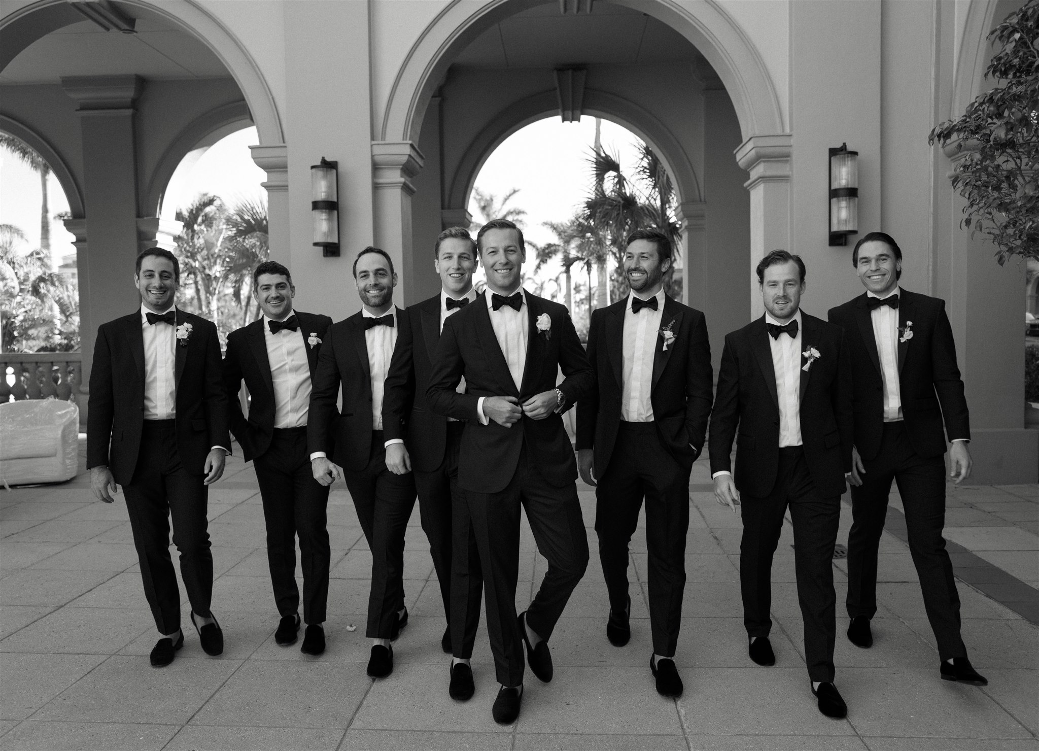 Black and white photo of groom and groomsmen in black tuxes