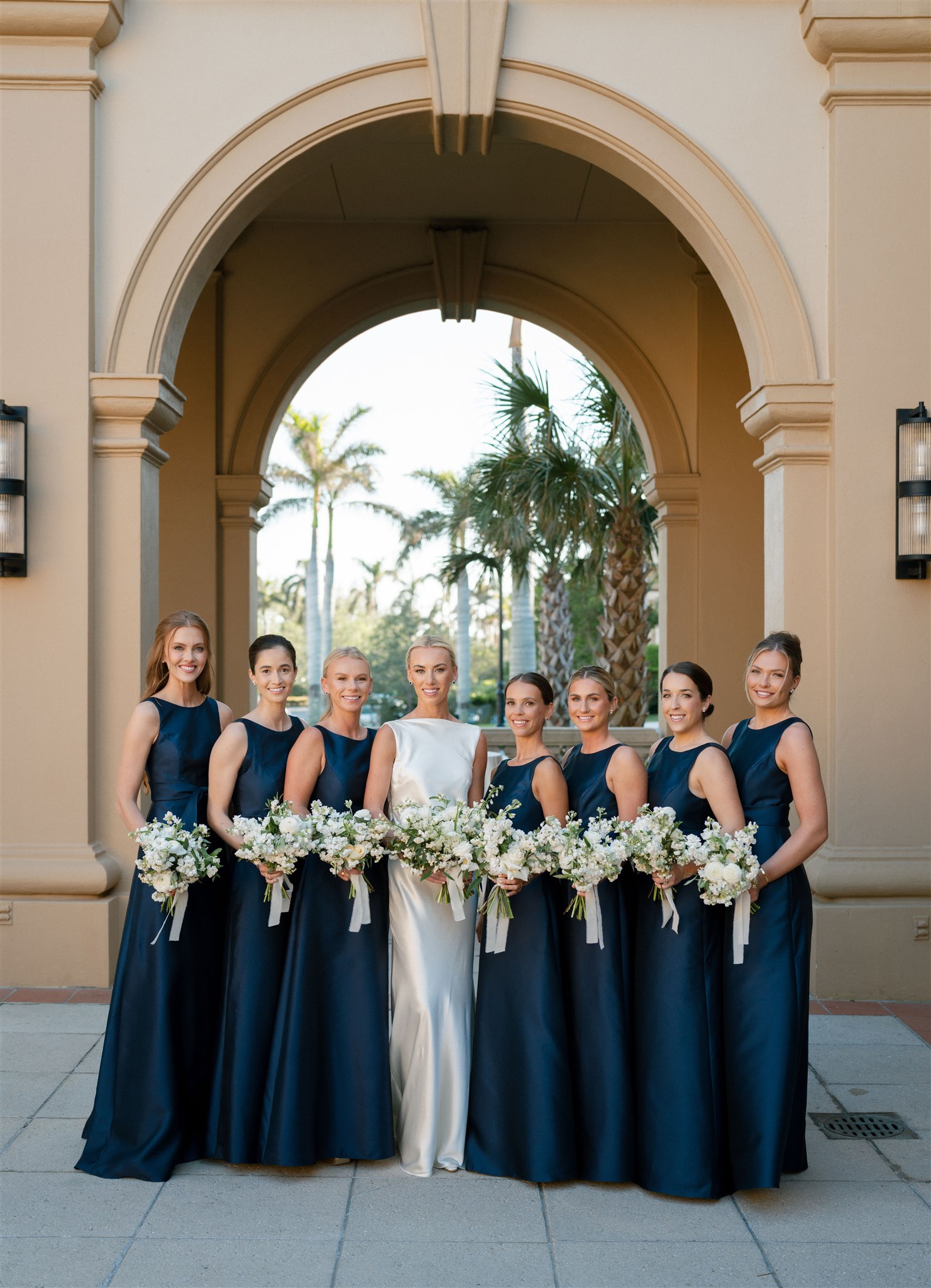 Bridal party in navy blue with white bouquets at Ritz Carlton Naples