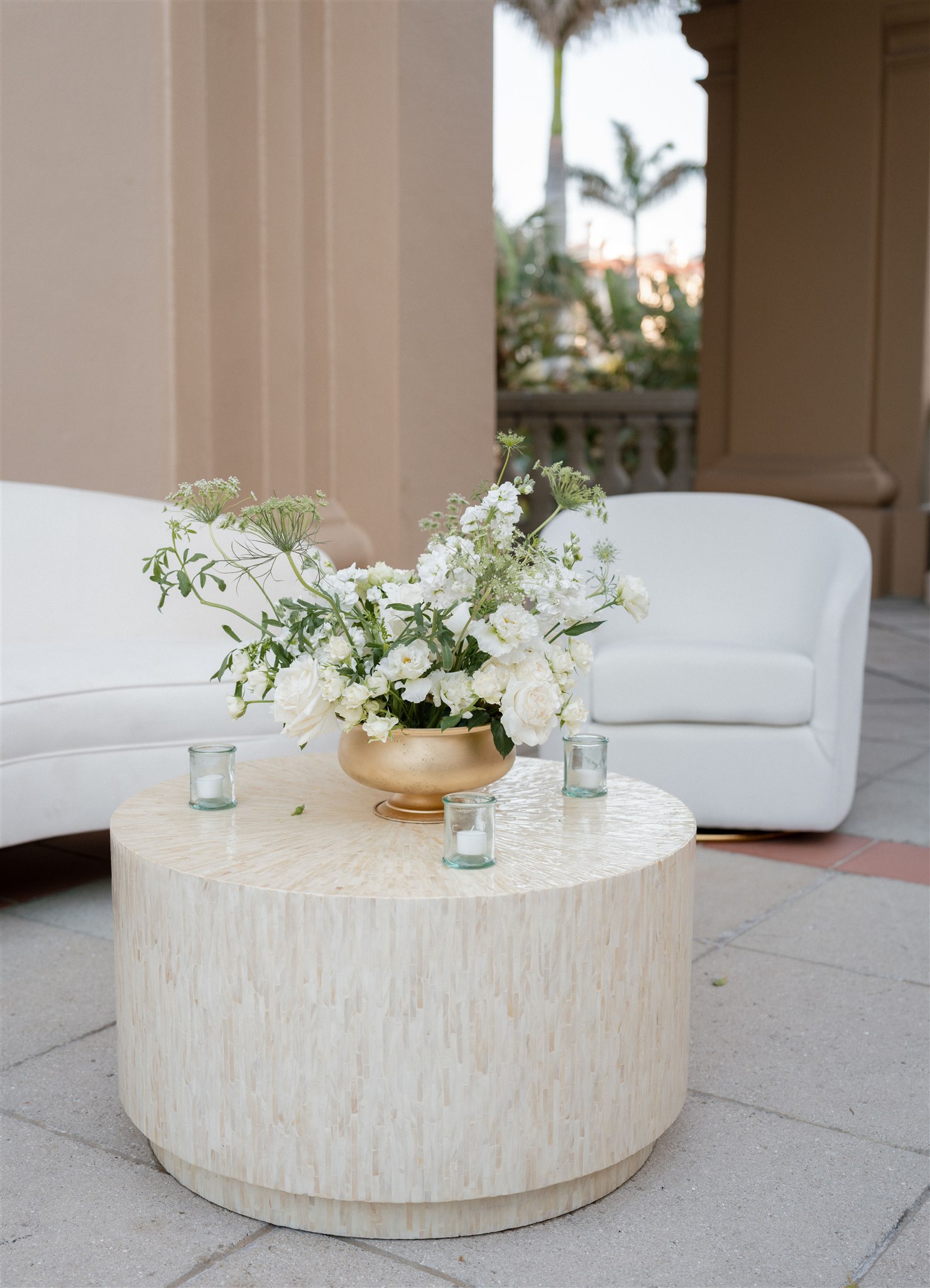 Wedding lounge seating with white centerpiece, gold vase