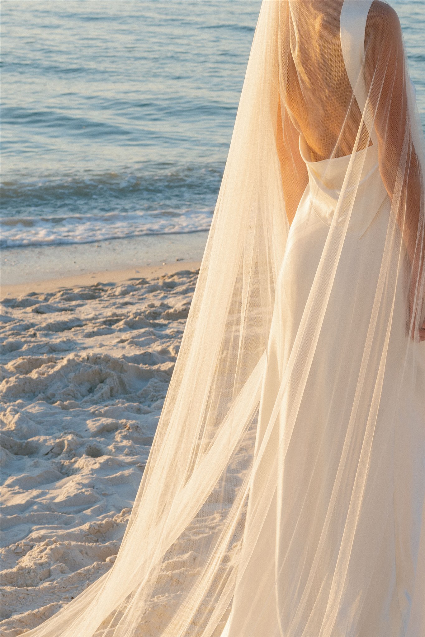 Bride on Naples, FL beach with cathedral veil
