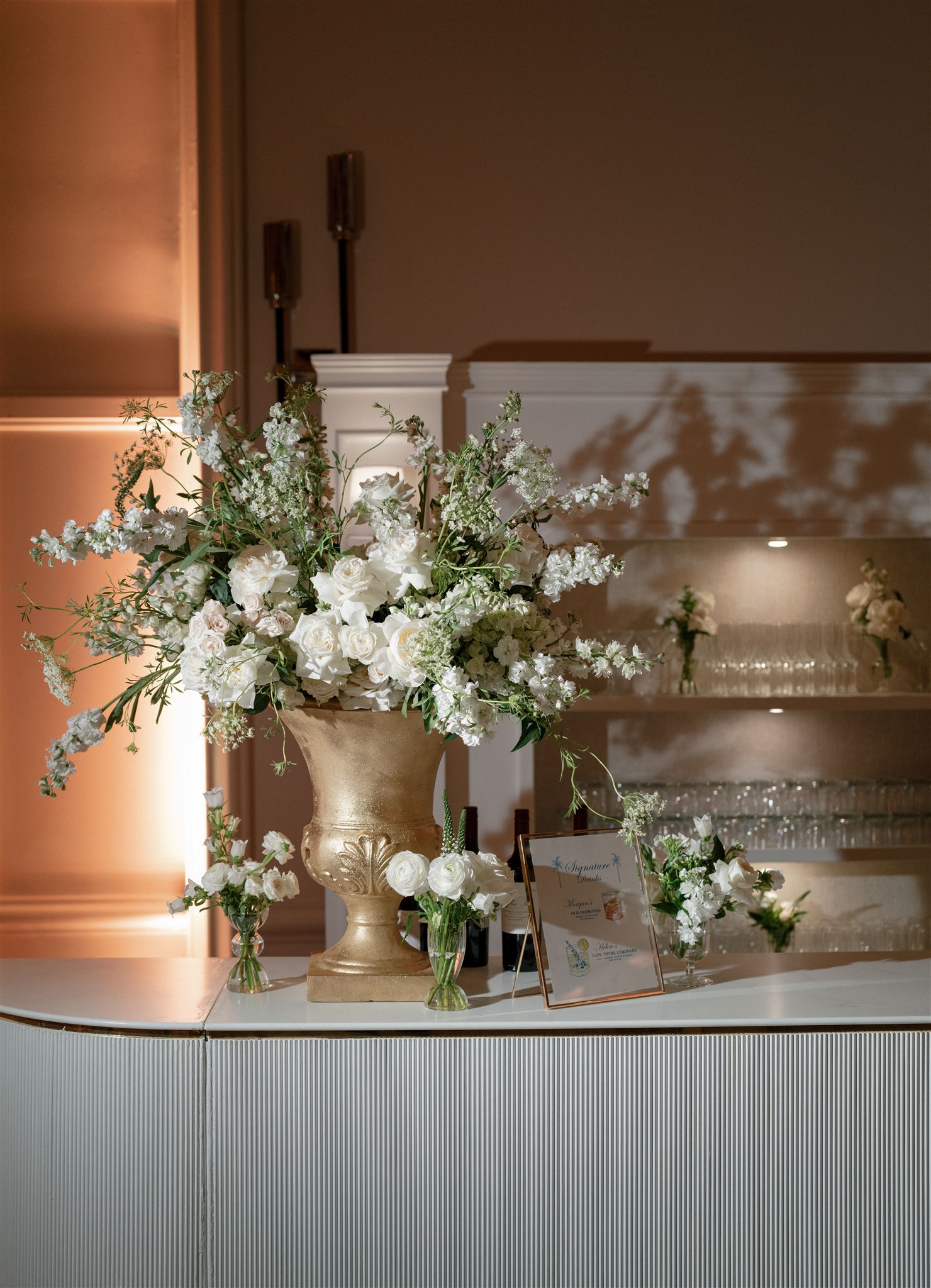 White reception arrangements on custom white bar