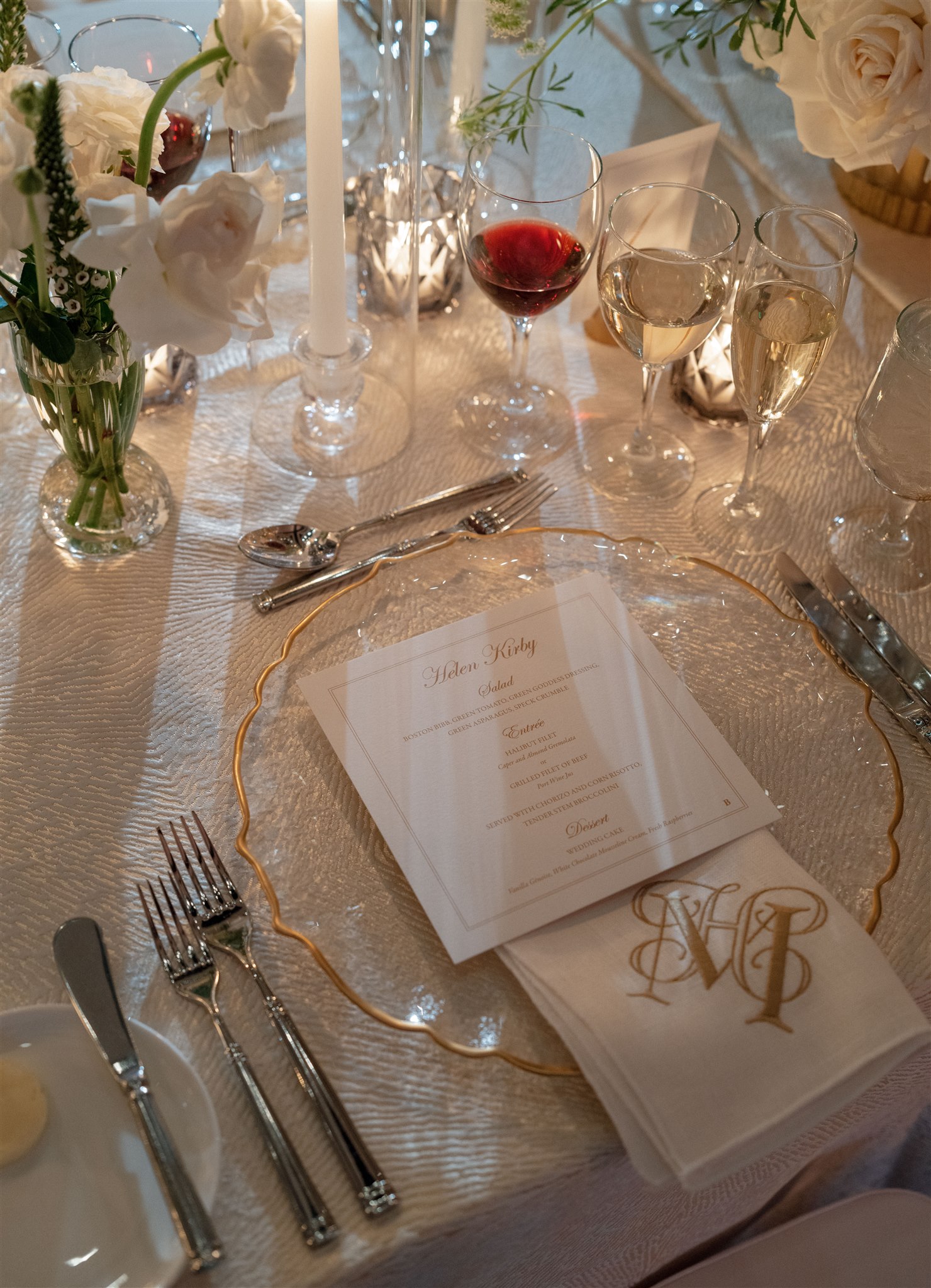 Gold rimmed glass charger with custom monogrammed fabric napkin