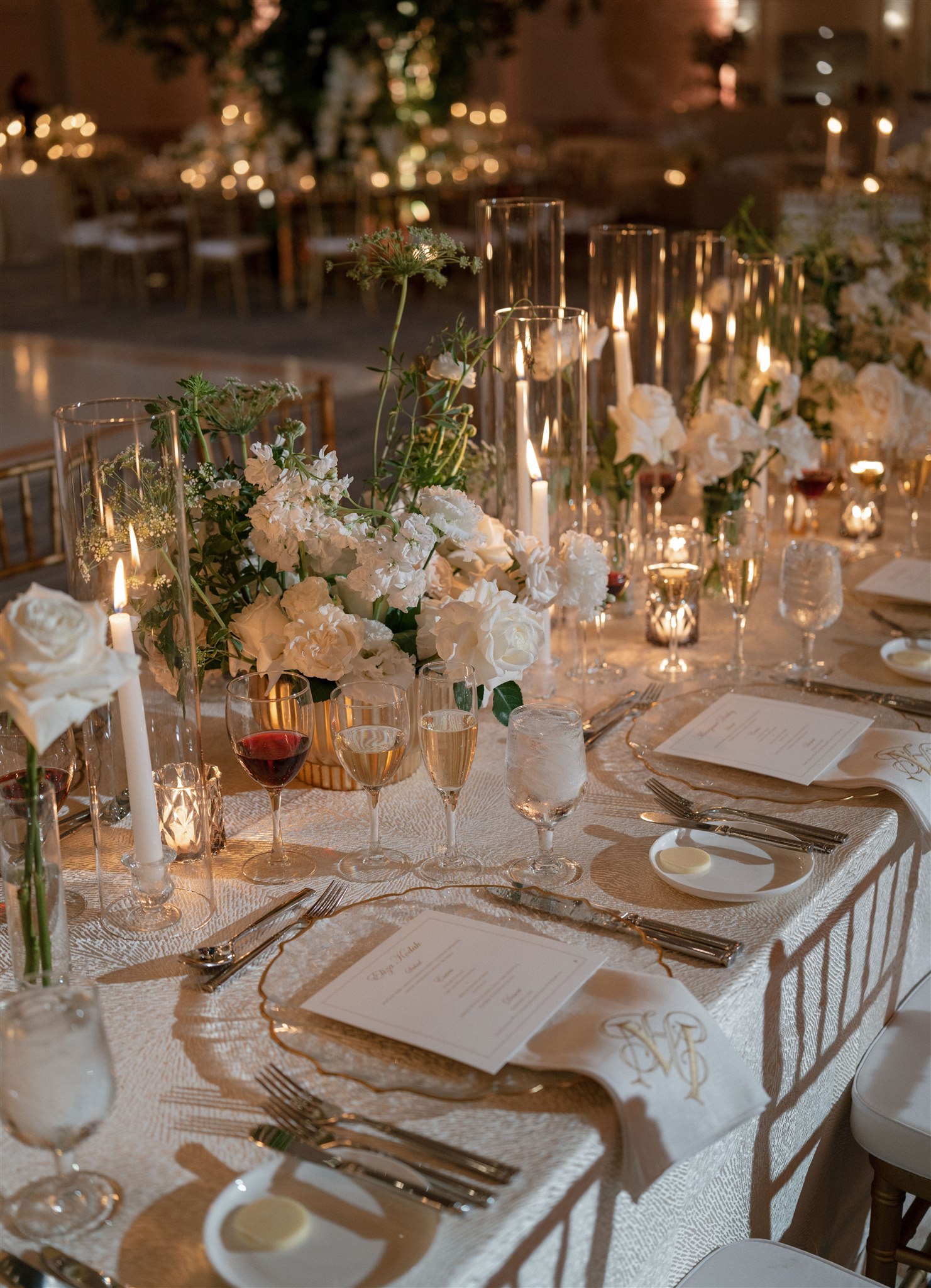 Wedding centerpiece with white florals, organic greenery