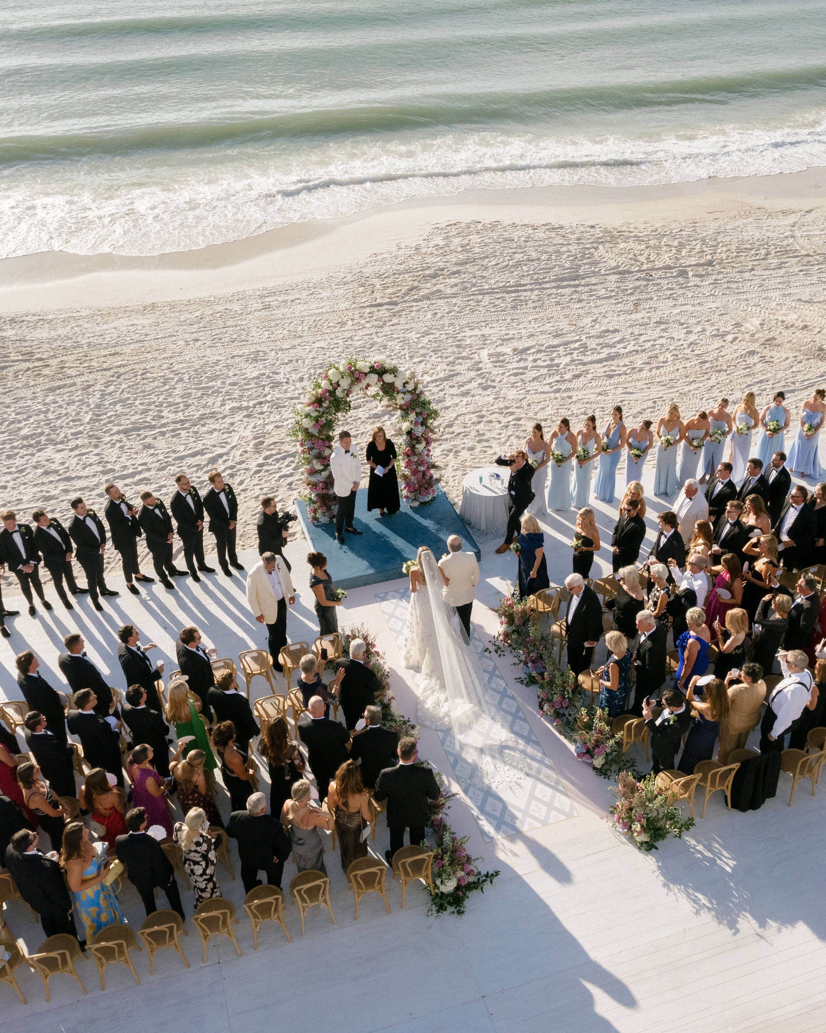 A couple shares vows on the beach in Florida in front of loved ones.