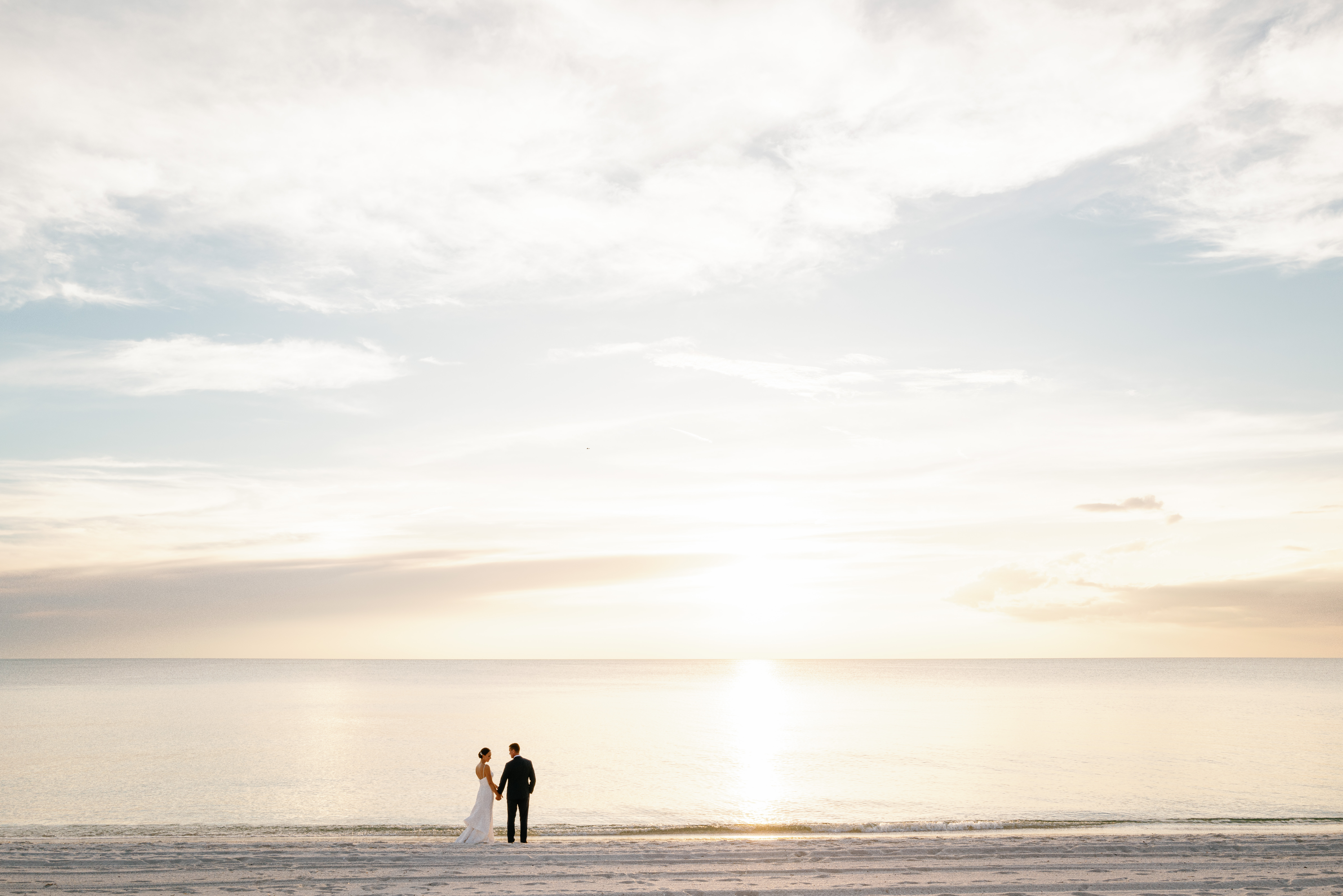 A couple on the beach in Naples Florida during their golden hour wedding portraits.