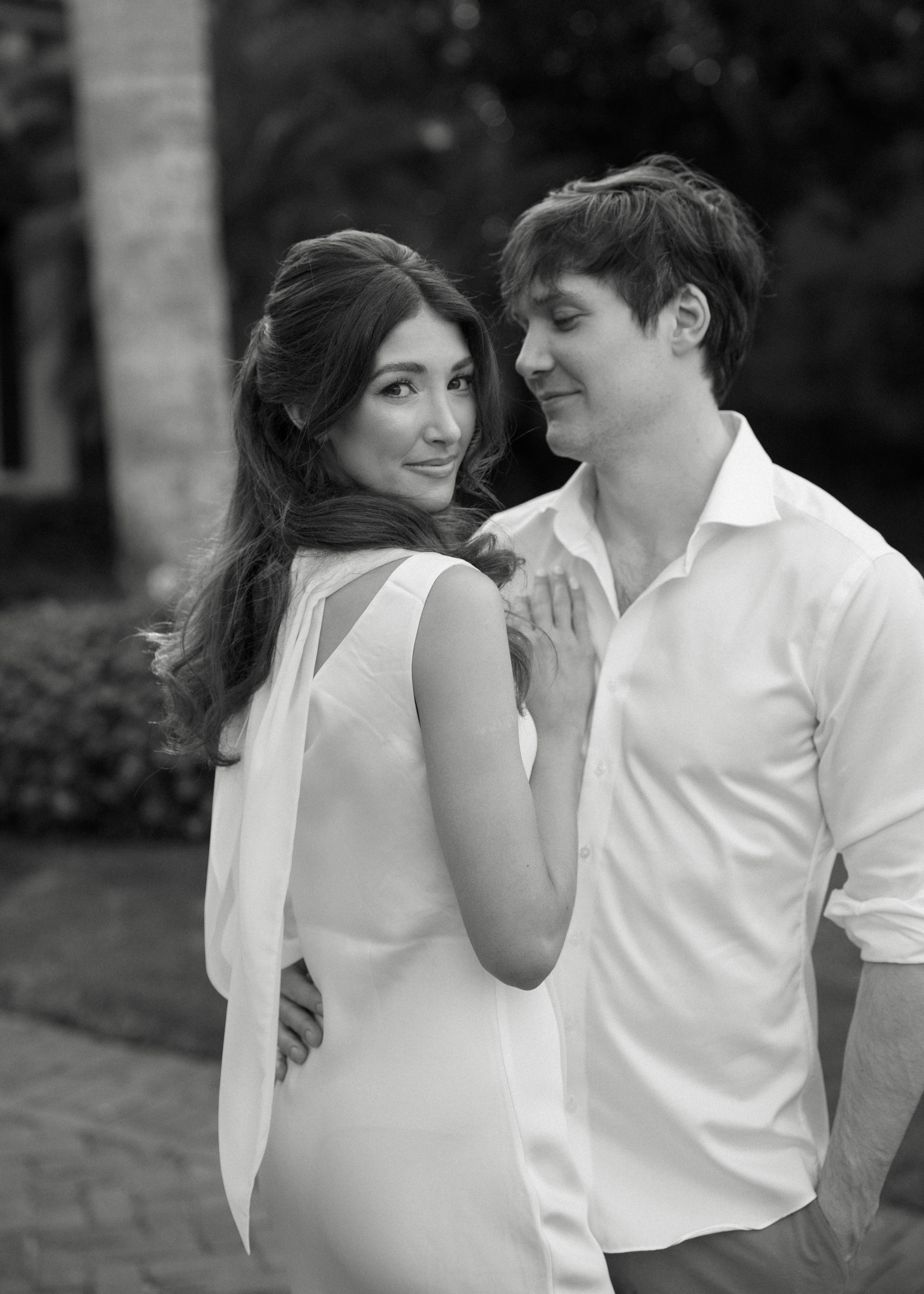 A black and white photo of a couple posing for Florida engagement portraits.