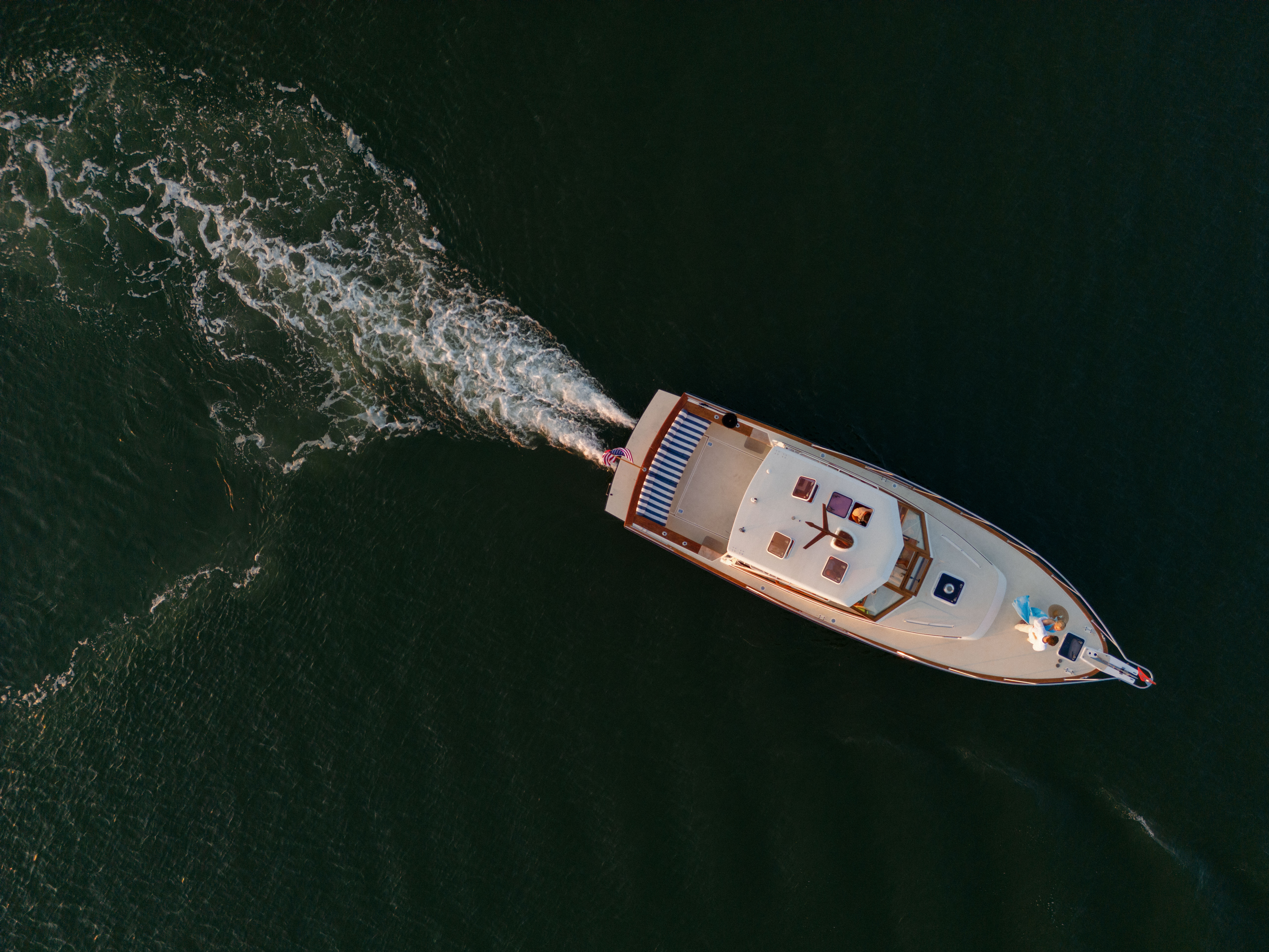 Aerial shot of a boat coasting through the water in Charleston.