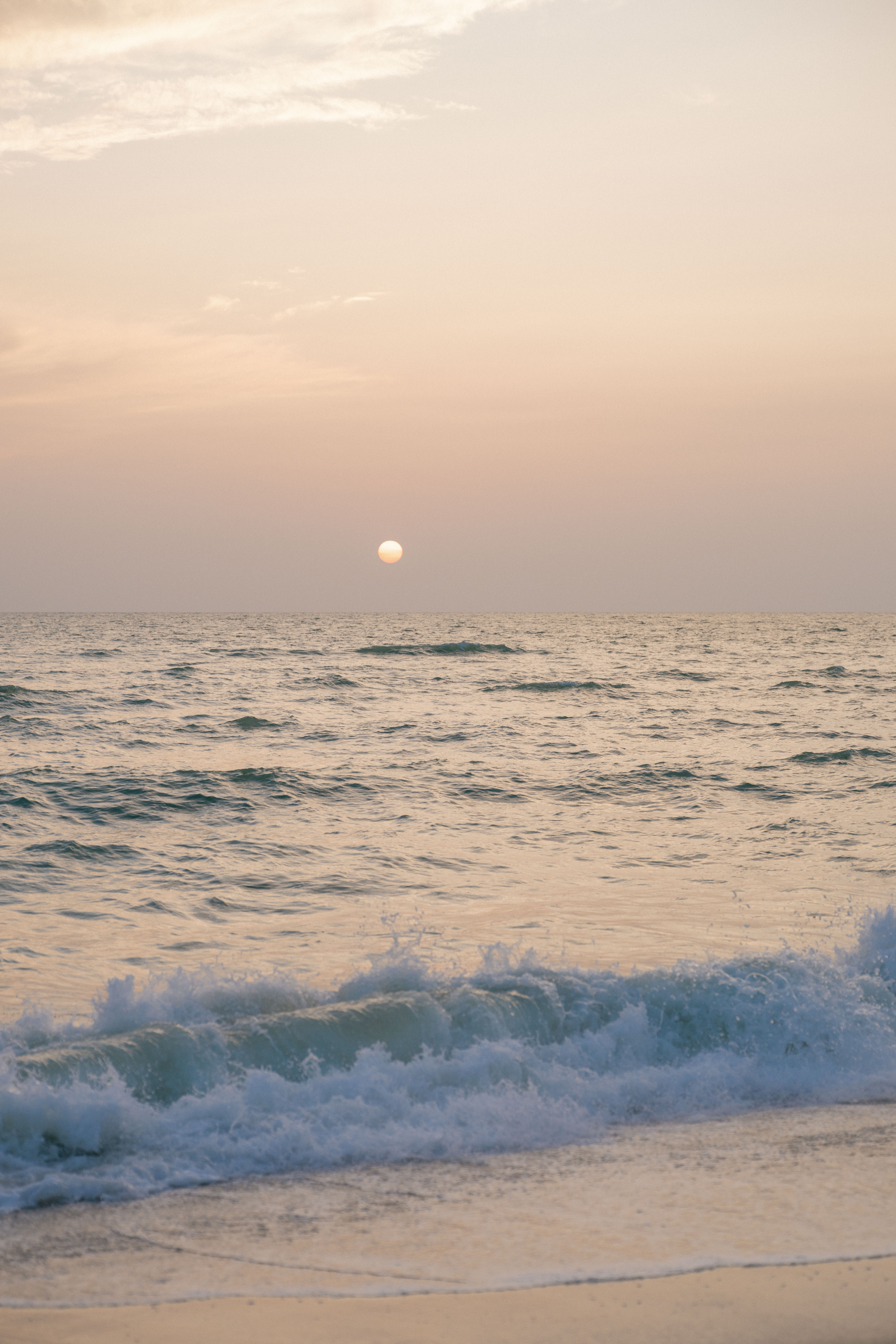 The sun setting on a beach in Naples, Florida.