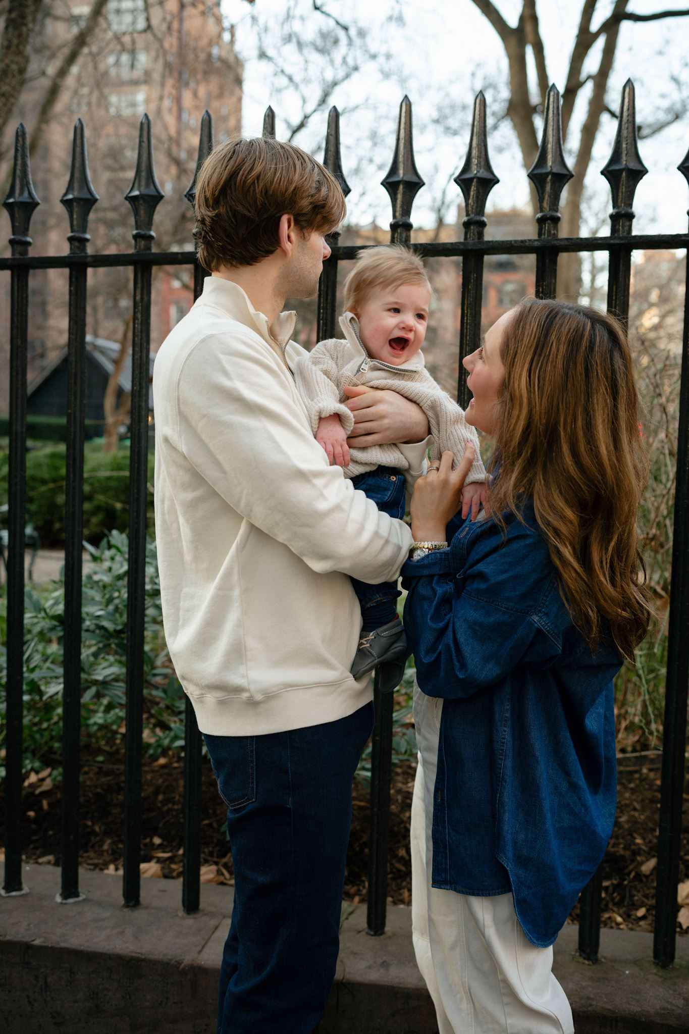Family portrait in New York City at a park gate.