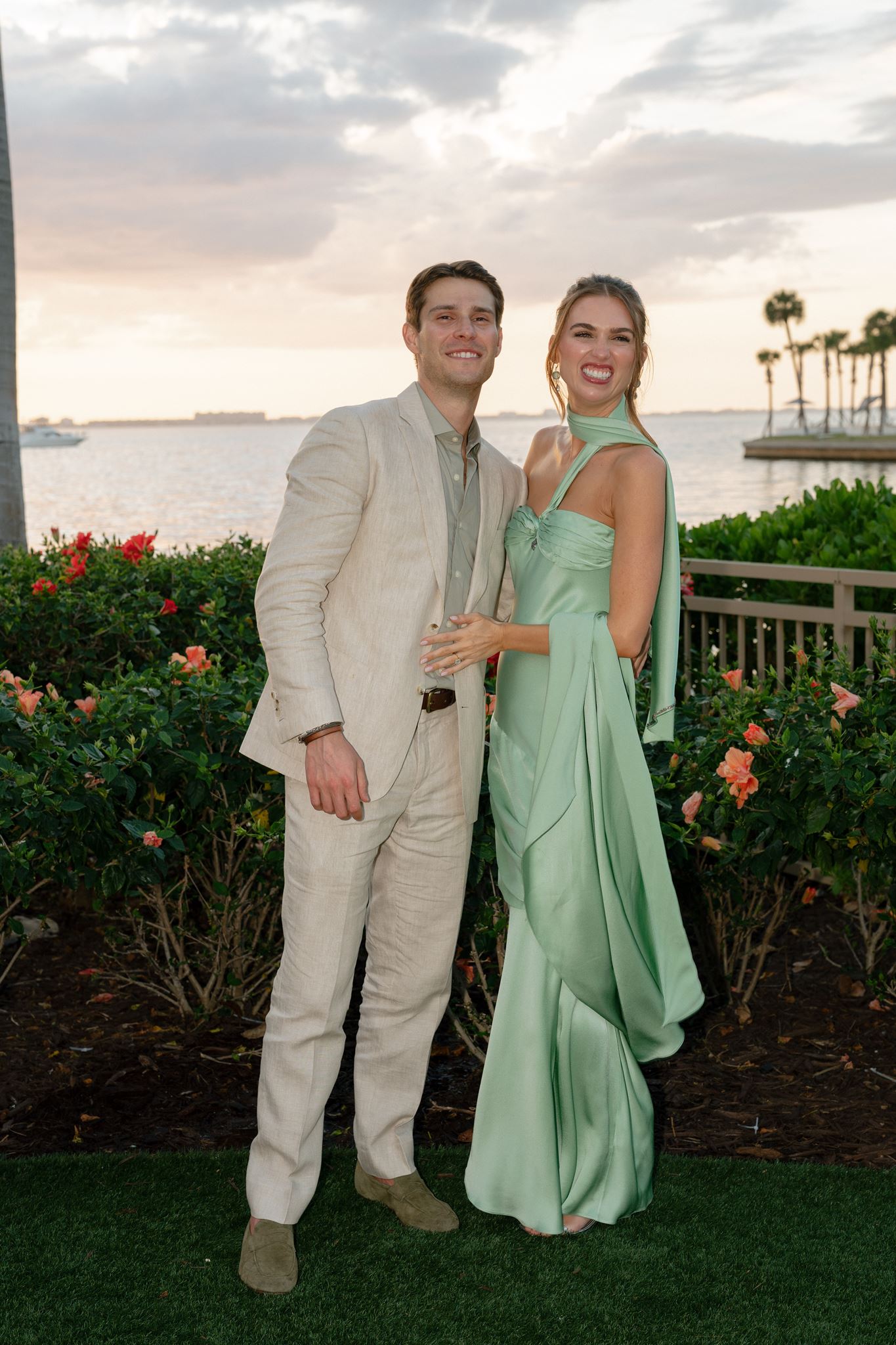 Bride and groom-to-be posing by the water at their Ritz-Carlton, Sarasota welcome dinner.