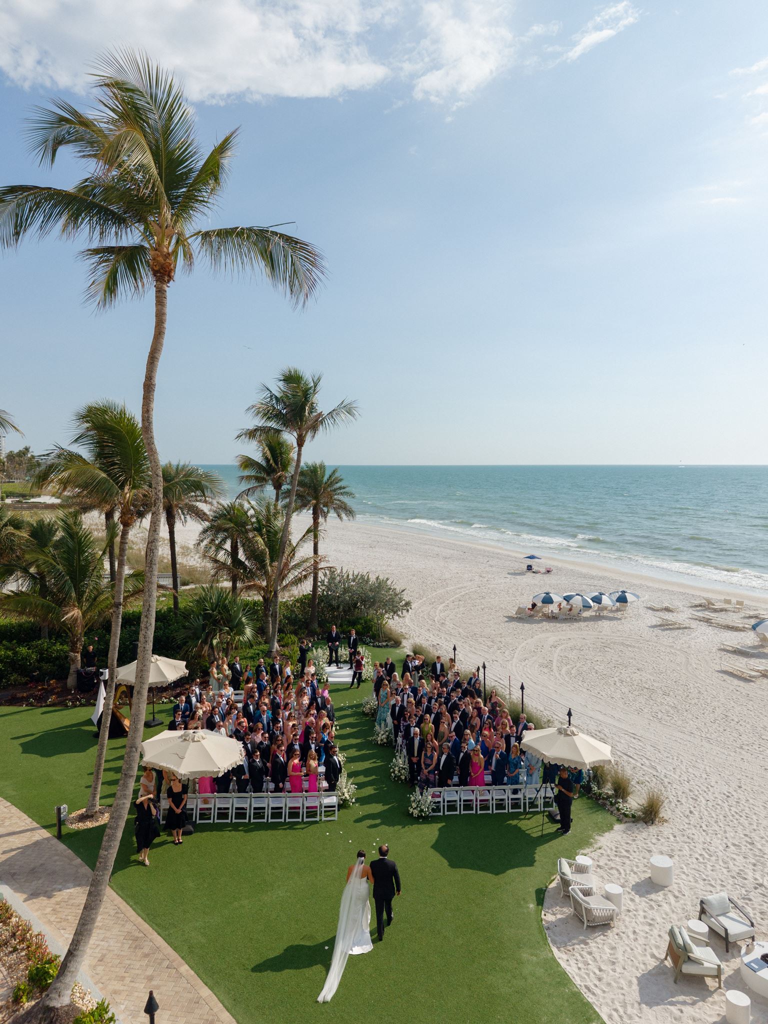 A bride prepares to walk down the aisle at her oceanside wedding ceremony at LaPlaya Naples.