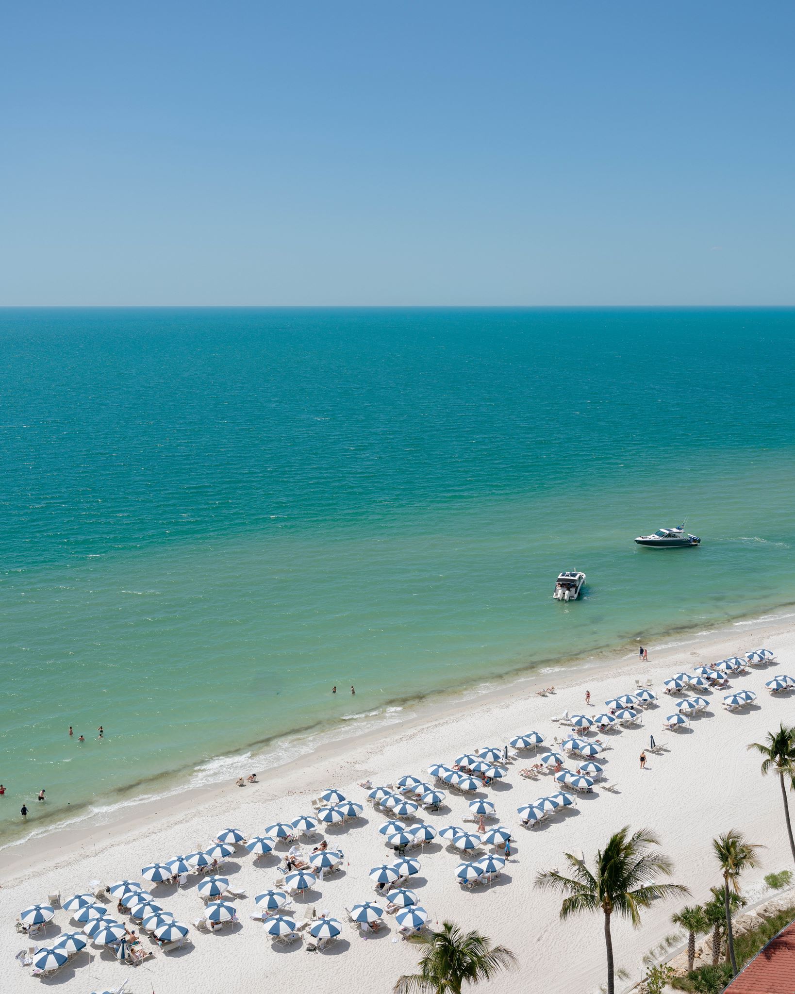 Naples beach with blue water and white sand.
